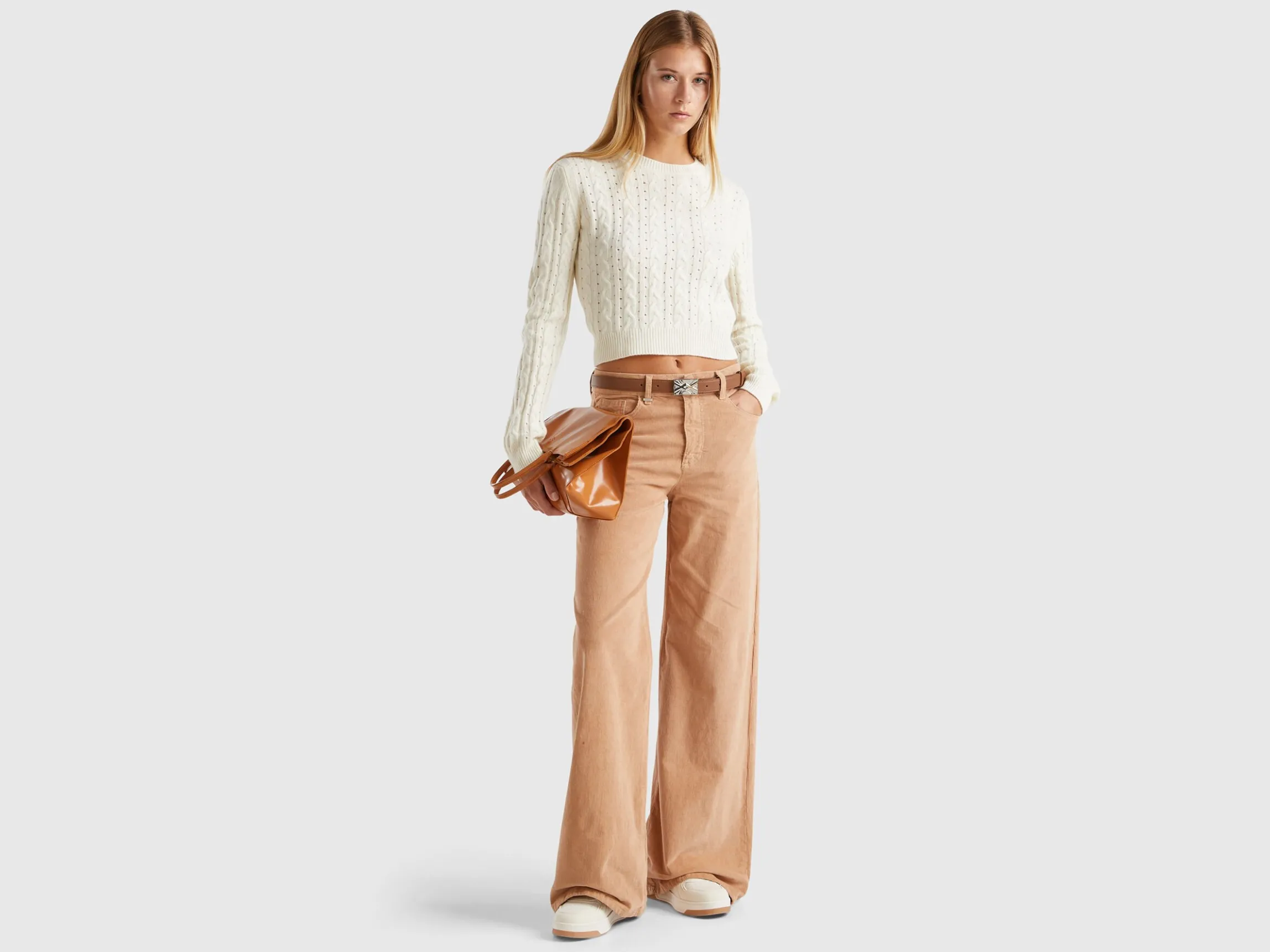 Cropped sweater with cable knit and perforations