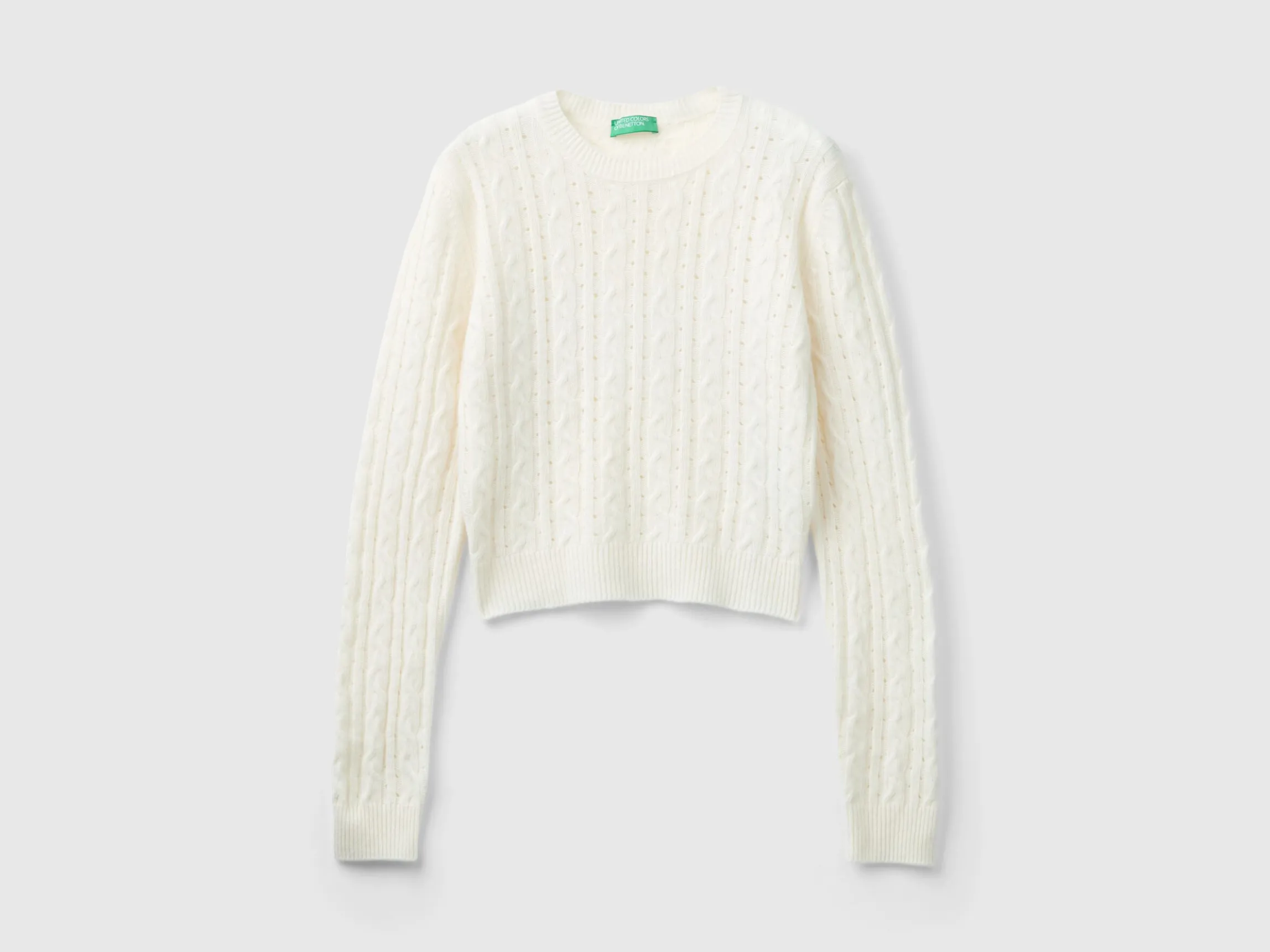 Cropped sweater with cable knit and perforations