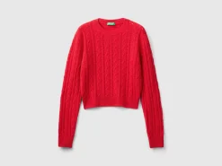Cropped sweater with cable knit and perforations