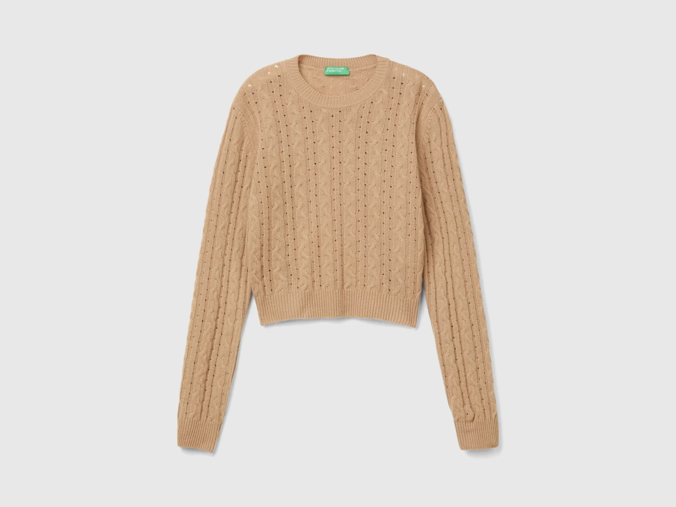 Cropped sweater with cable knit and perforations