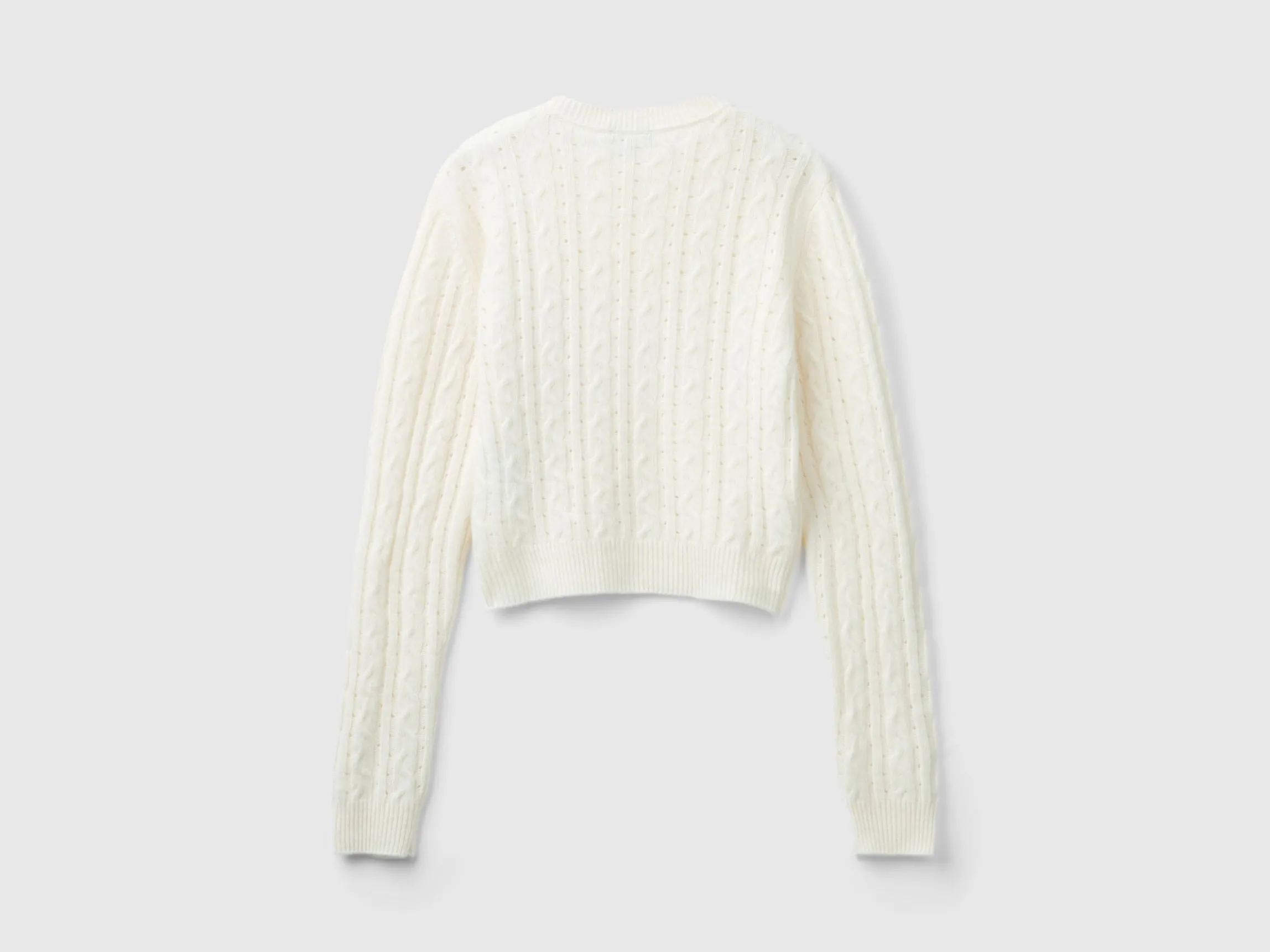 Cropped sweater with cable knit and perforations