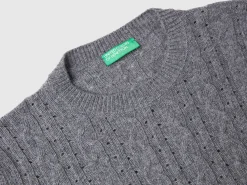 Cropped sweater with cable knit and perforations