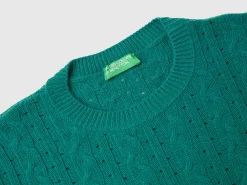 Cropped sweater with cable knit and perforations
