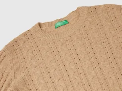 Cropped sweater with cable knit and perforations