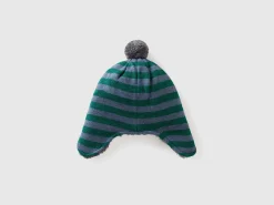 Hat with earflaps and pom pom