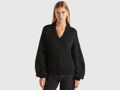 Sweater with perforated sleeve