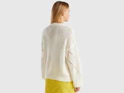 Sweater with perforated sleeve