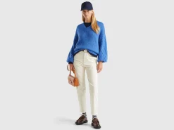 Sweater with perforated sleeve