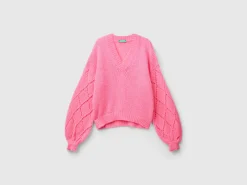 Sweater with perforated sleeve