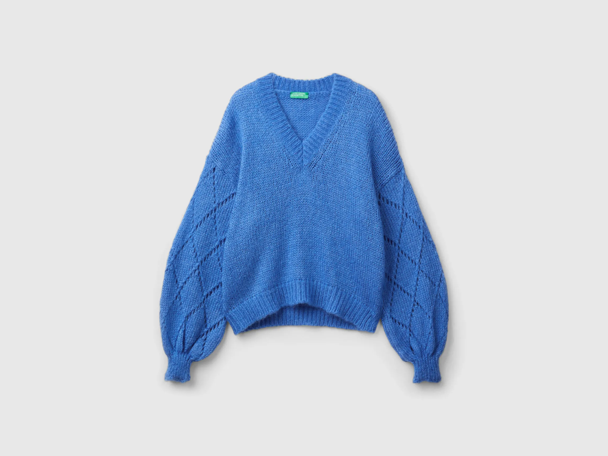 Sweater with perforated sleeve