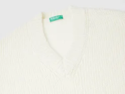 Sweater with perforated sleeve