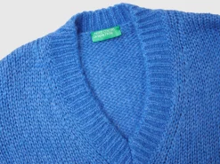Sweater with perforated sleeve