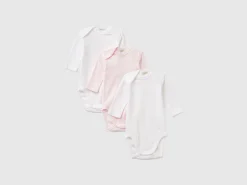 Three solid color bodysuits in organic cotton