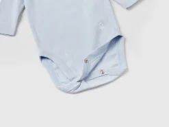 Three solid color bodysuits in organic cotton