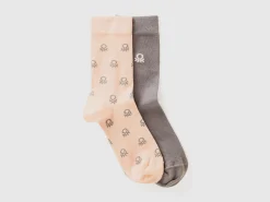 Two pairs of long socks with logos